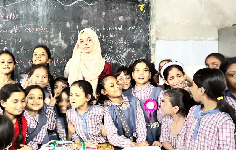 Isha Zehra Meer with students during a classroom teaching session